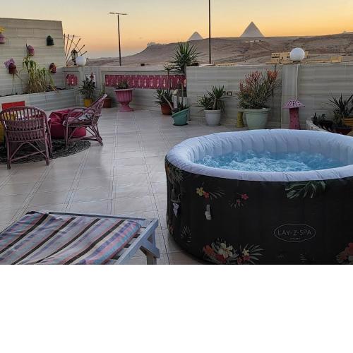 private rooftop with hot jacuzzi and pyramids view