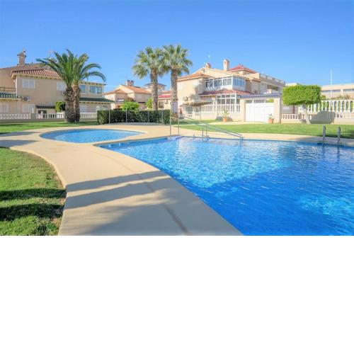Spacious ground floor apartment overlooking the beautiful communal pool